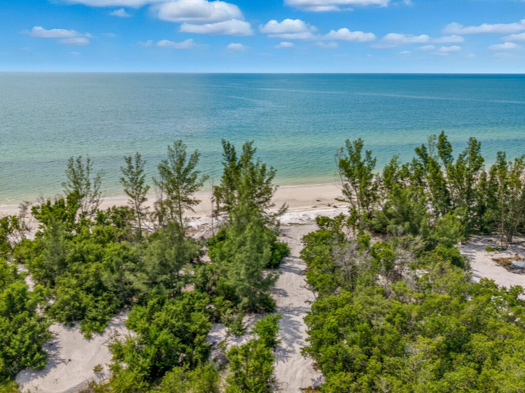 11799 Keewaydin Naples, FL 34113 - Photo 13 of 18 a view of a lake with a yard