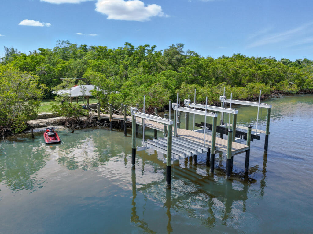 11799 Keewaydin Naples, FL 34113 - Photo 6 of 18 a balcony with table and chairs