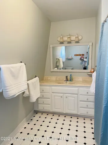 a bathroom with a sink a vanity and a mirror