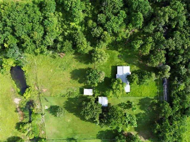 an aerial view of a residential houses with outdoor space