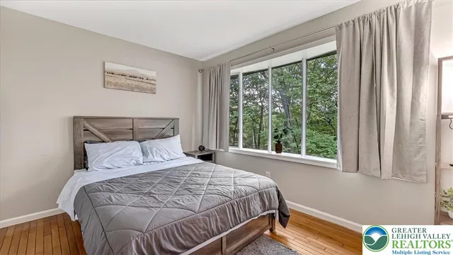 a bed sitting in a bedroom next to a window