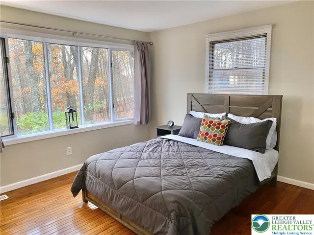 a bedroom with a bed and window