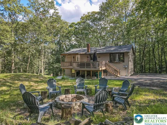 an aerial view of a house with swimming pool and a yard