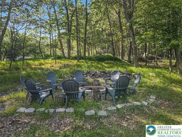 a view of a field with trees in the background