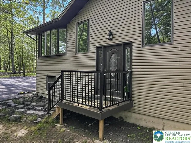 a view of a backyard with a large window and wooden fence