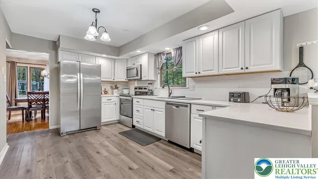 a kitchen with a refrigerator sink and cabinets