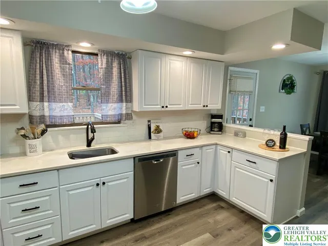 a kitchen with a sink cabinets and window