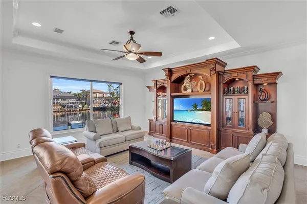 a living room with furniture a rug and a flat screen tv