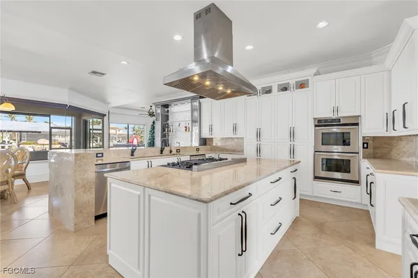 a kitchen with stainless steel appliances granite countertop a sink and cabinets