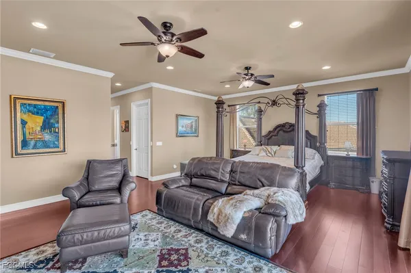 a bedroom with a bed couch and a window