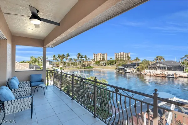 a view of a balcony dining table and chairs