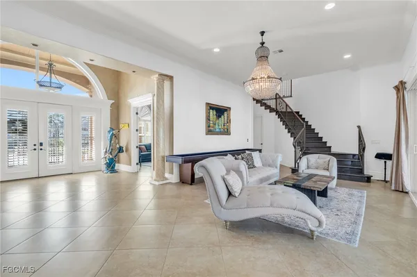 a living room with furniture and a chandelier