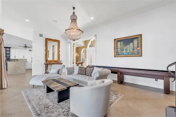 a living room with furniture and a chandelier