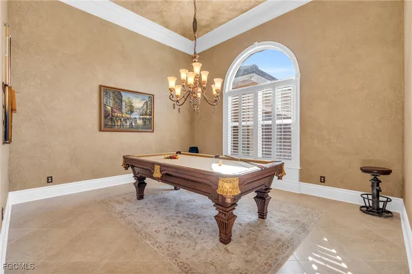 a room with pool table and windows