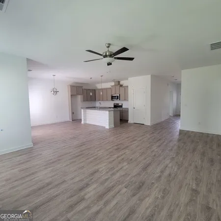 a view of a kitchen with a sink and a refrigerator