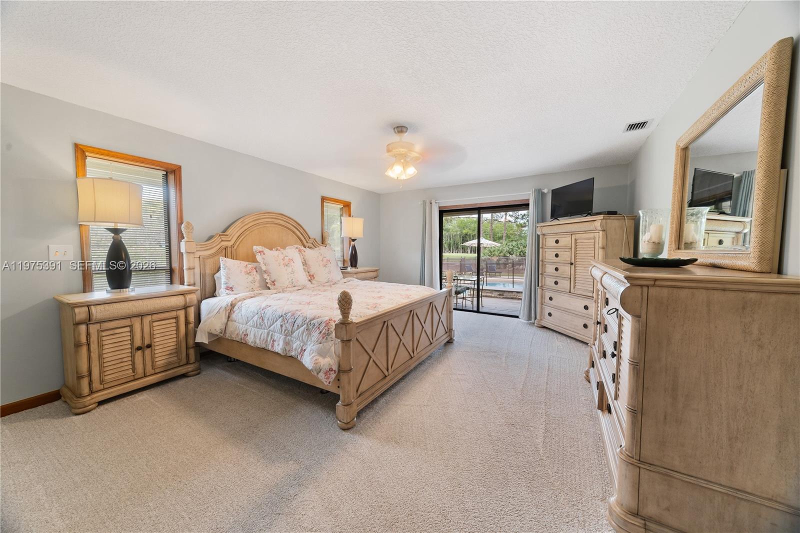 1872 Southeast Colony Way Jupiter, FL 33478 - Photo 17 of 26 a bedroom with a large bed and a dresser