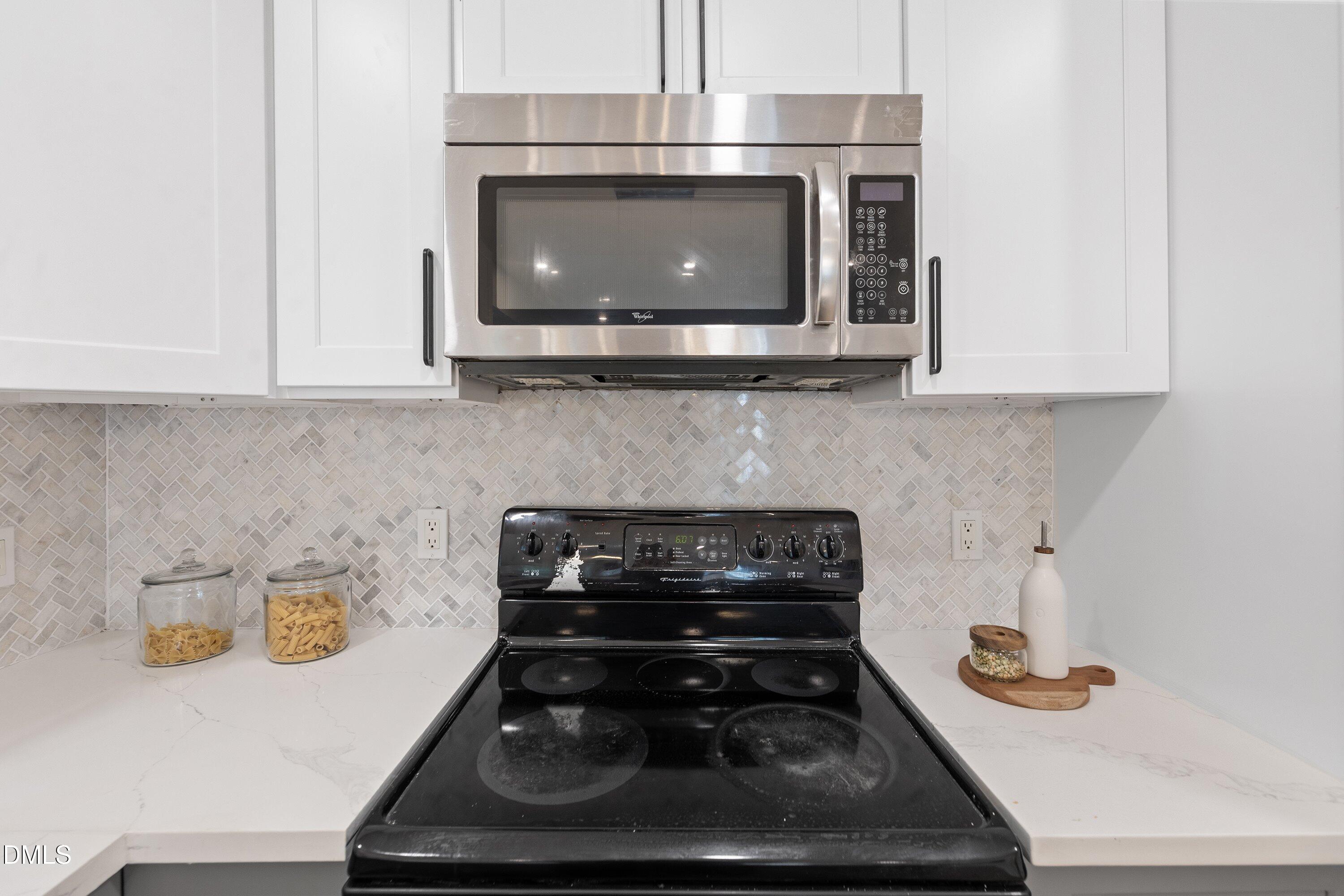 2517 Birchford Court Raleigh, NC 27604 - Photo 30 of 63 a kitchen with a stove and a microwave