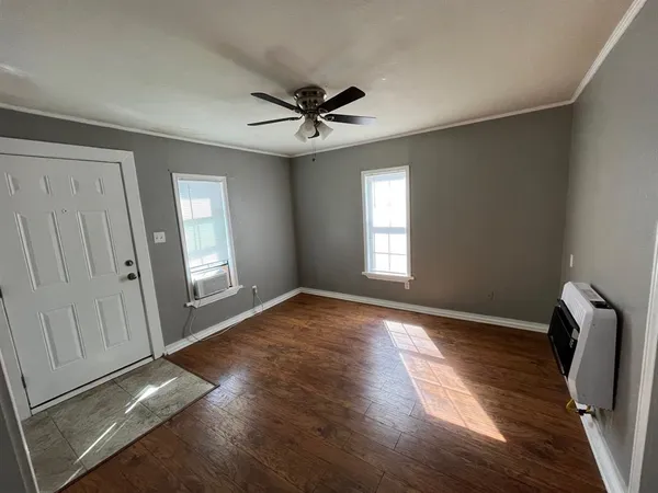 wooden floor in an empty room with a window