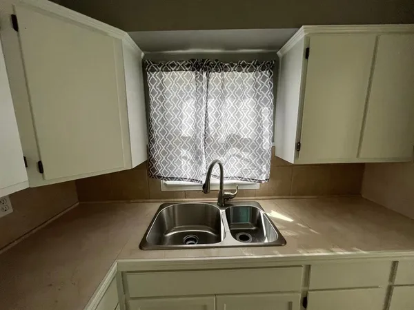 a sink sitting next to a window