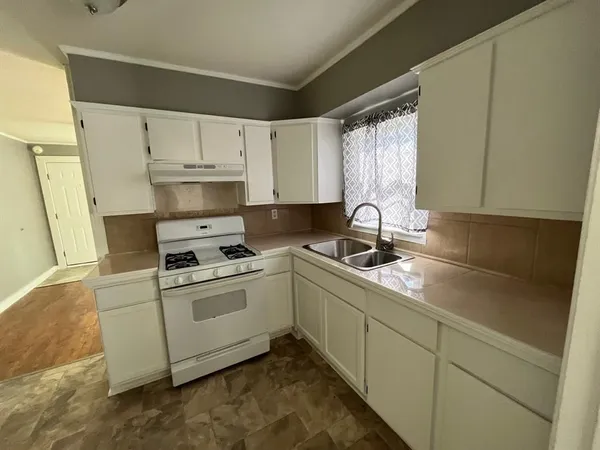 a kitchen with cabinets a sink and appliances
