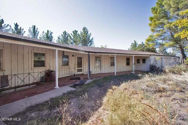 a view of a livingroom with furniture a fireplace and wooden floor