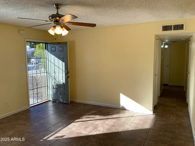 a view of a livingroom with a hardwood floor and a ceiling fan