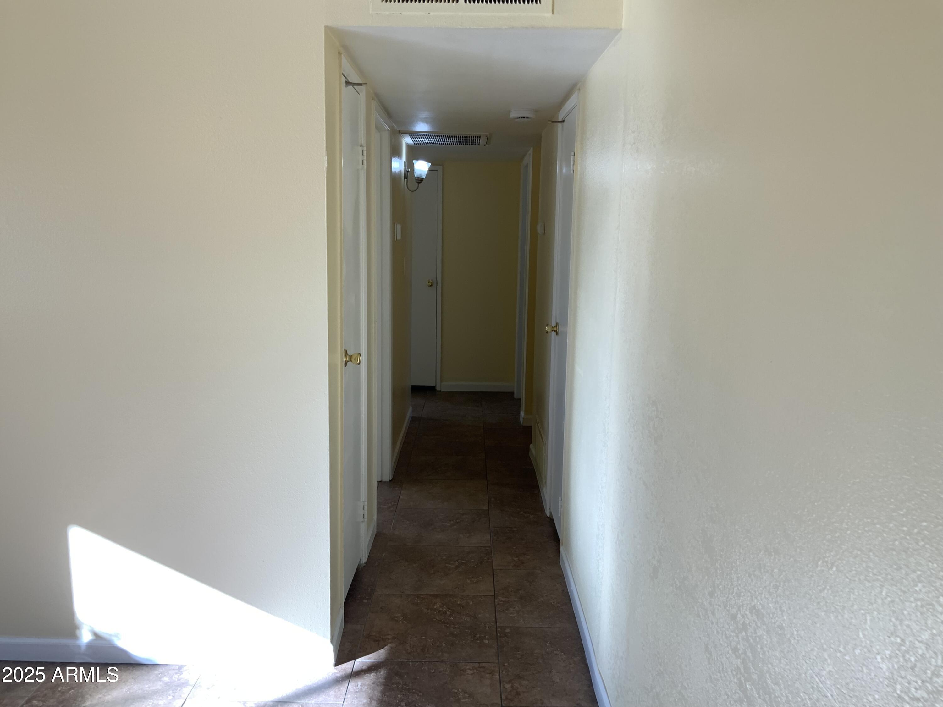 15831 North 59th Circle Glendale, AZ 85306 - Photo 4 of 12 a view of a hallway with wooden floor
