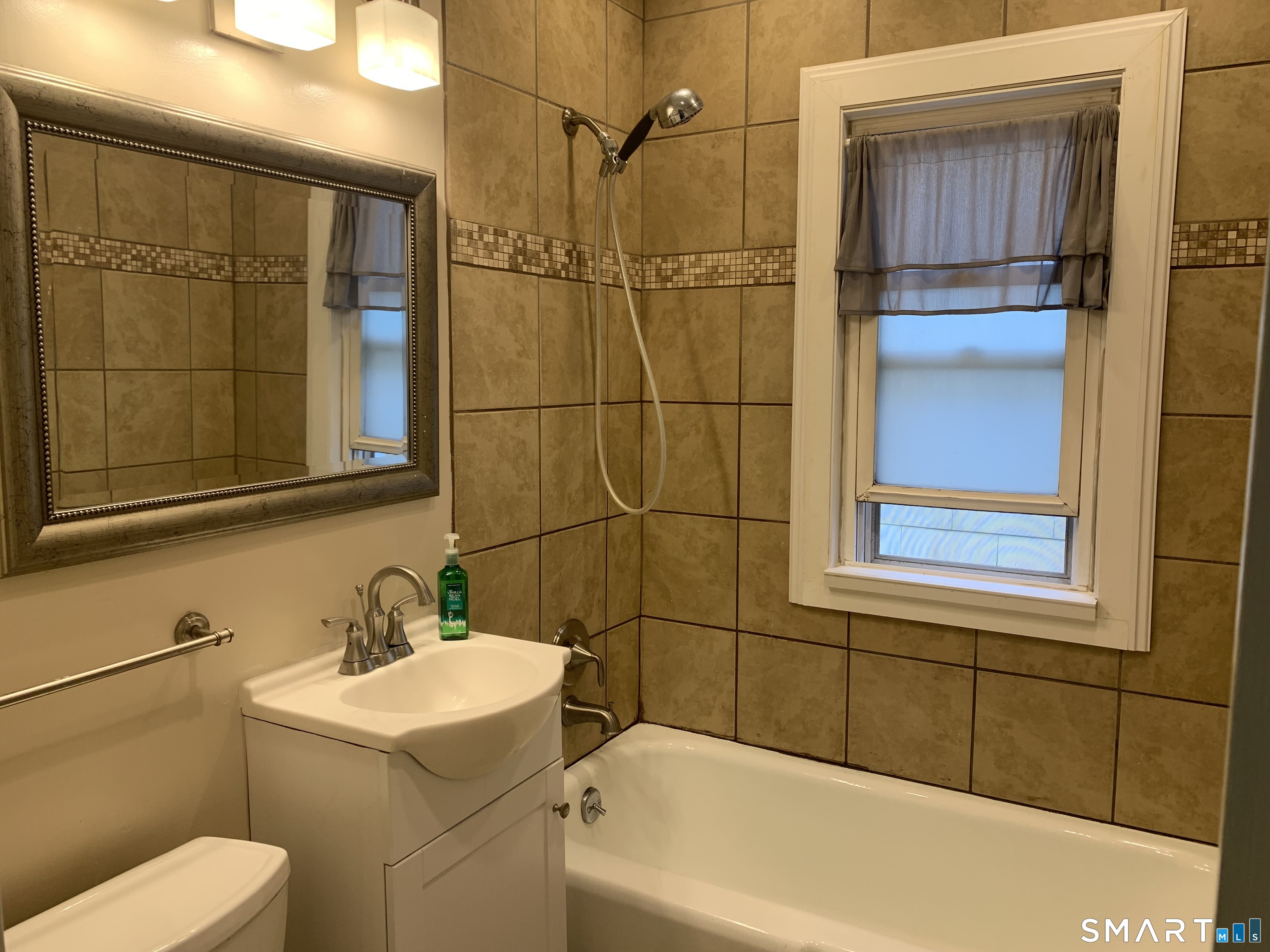 112 Austin Street New Britain, CT 06051 - Photo 16 of 40 a bathroom with a sink a toilet and shower