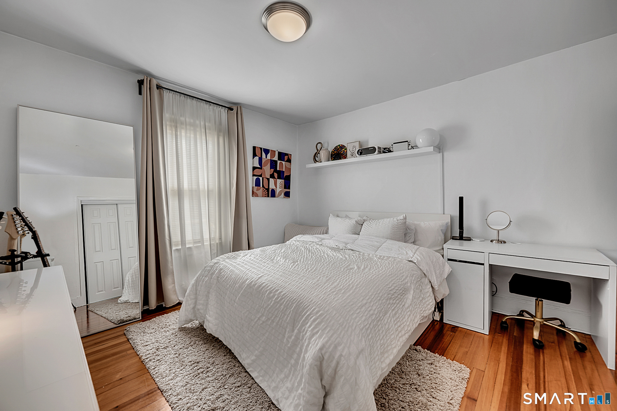 112 Austin Street New Britain, CT 06051 - Photo 21 of 40 a bedroom with a bed and wooden floor