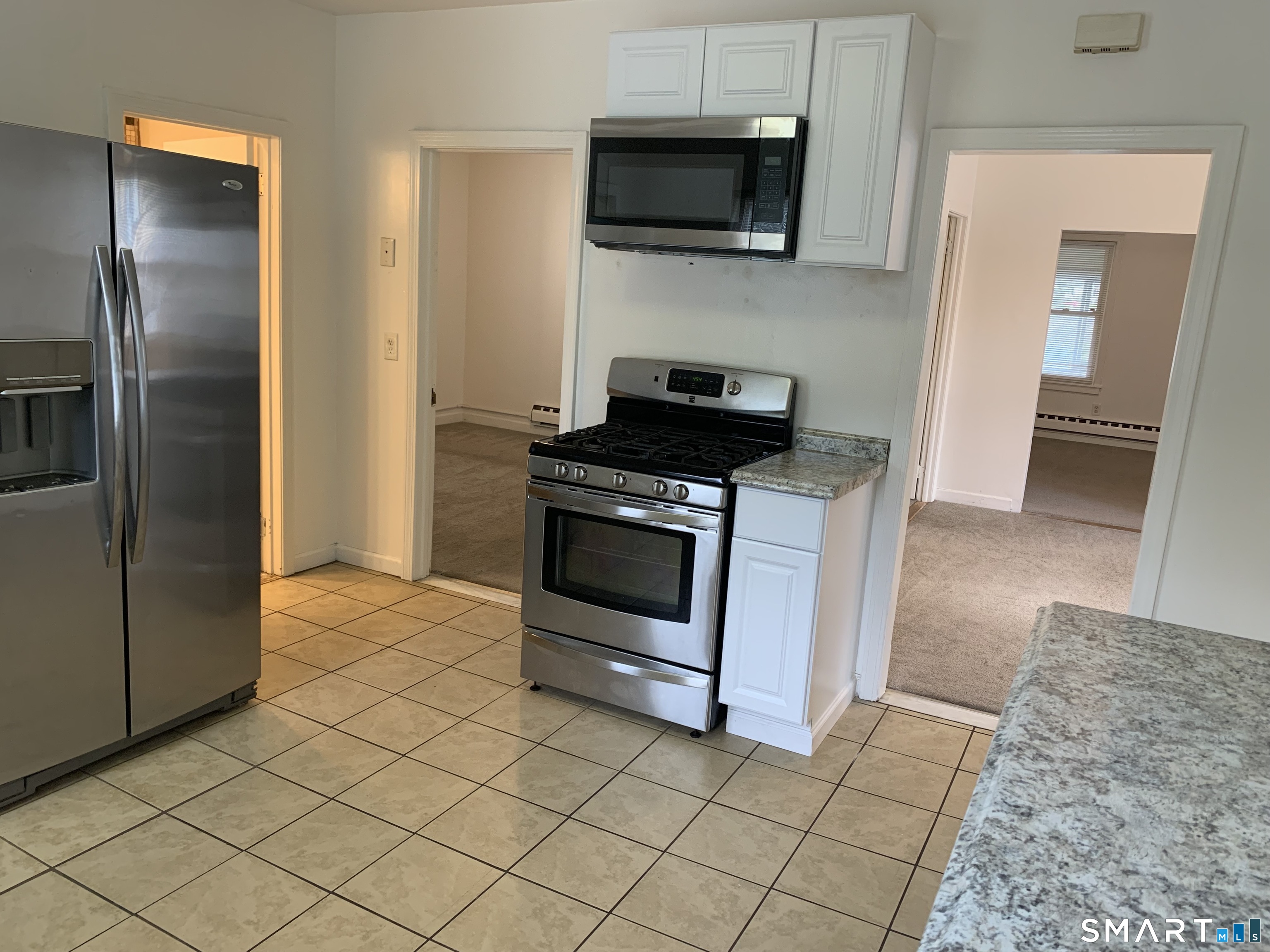 112 Austin Street New Britain, CT 06051 - Photo 7 of 40 a kitchen with stainless steel appliances granite countertop a stove a microwave and a refrigerator
