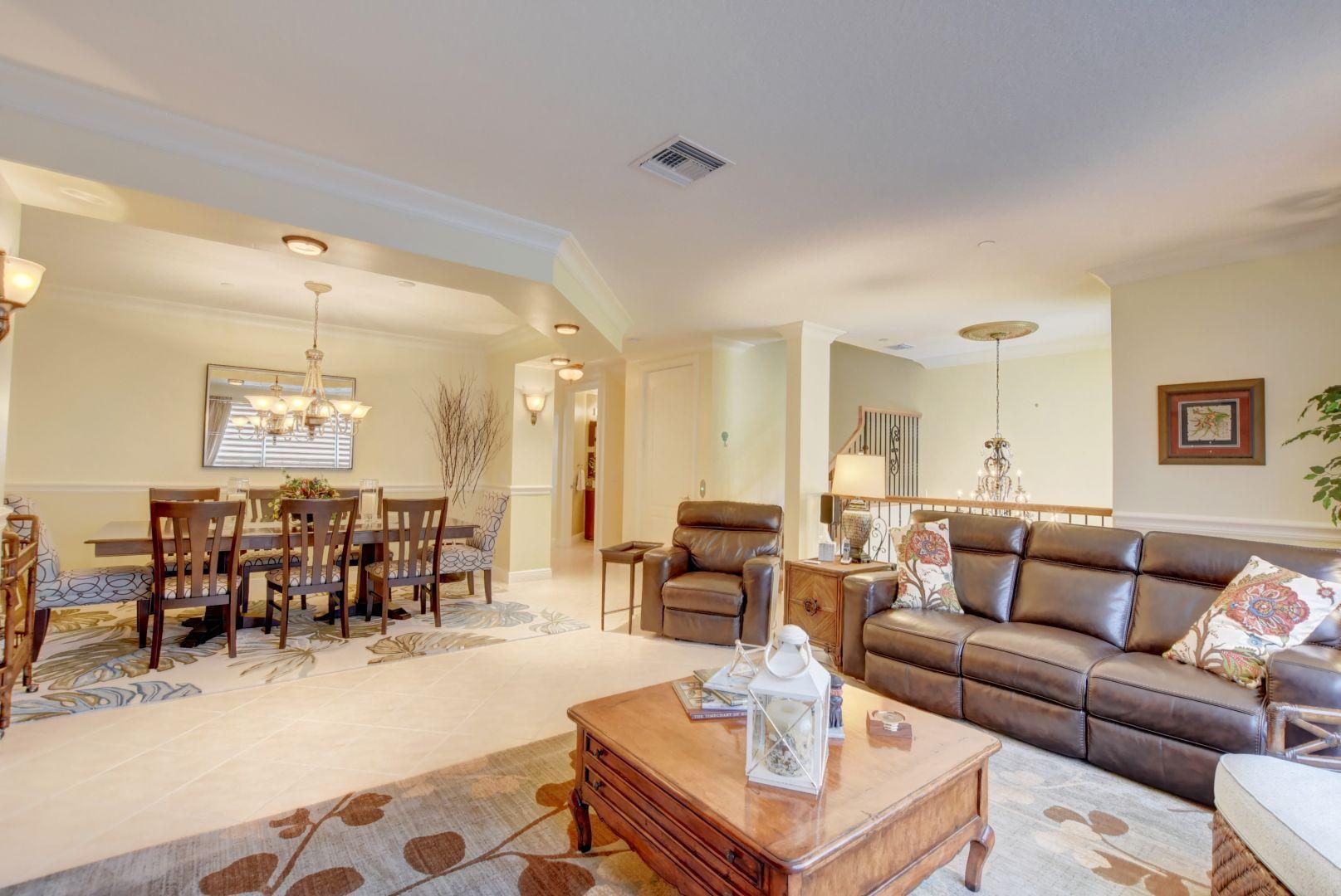 5530 Northeast Trieste Way Boca Raton, FL 33487 - Photo 12 of 56 a living room with lots of furniture and view of kitchen