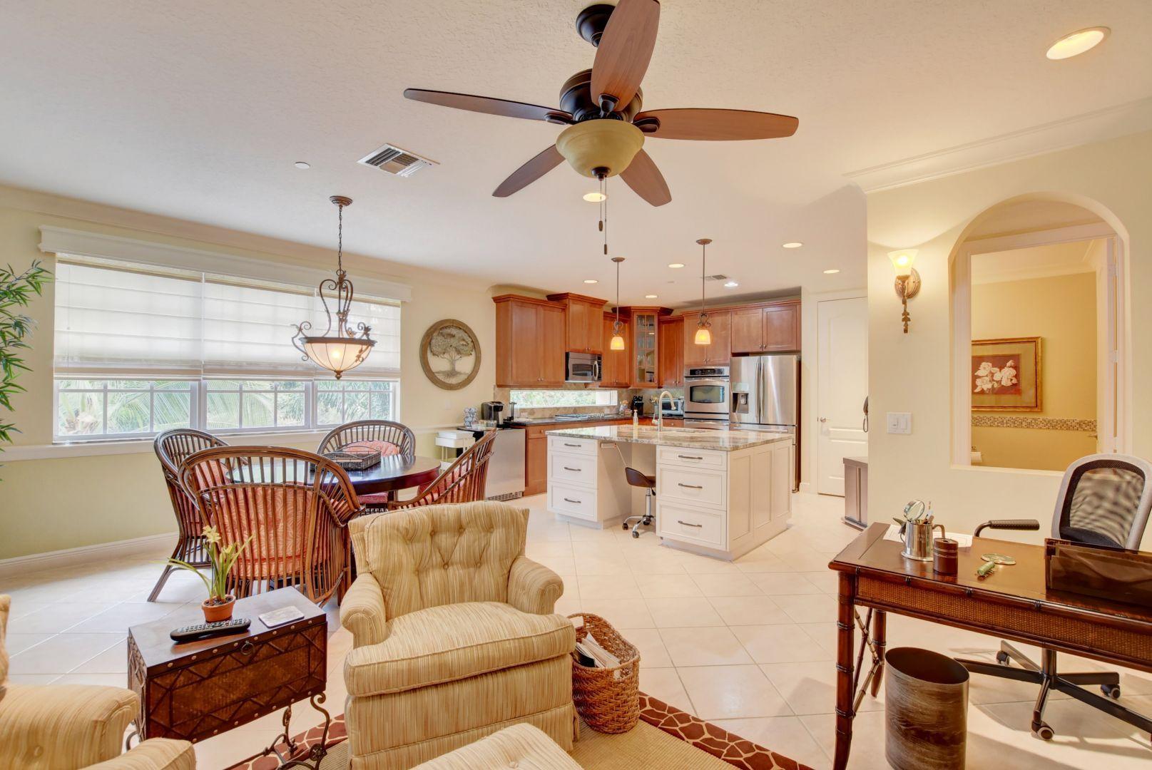 5530 Northeast Trieste Way Boca Raton, FL 33487 - Photo 13 of 56 a living room with furniture kitchen view and a chandelier