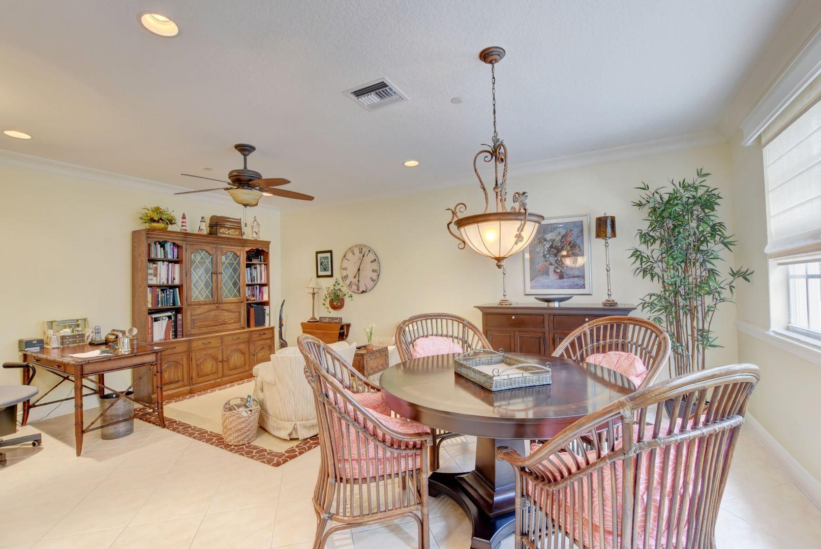 5530 Northeast Trieste Way Boca Raton, FL 33487 - Photo 16 of 56 a view of a dining room with furniture and chandelier