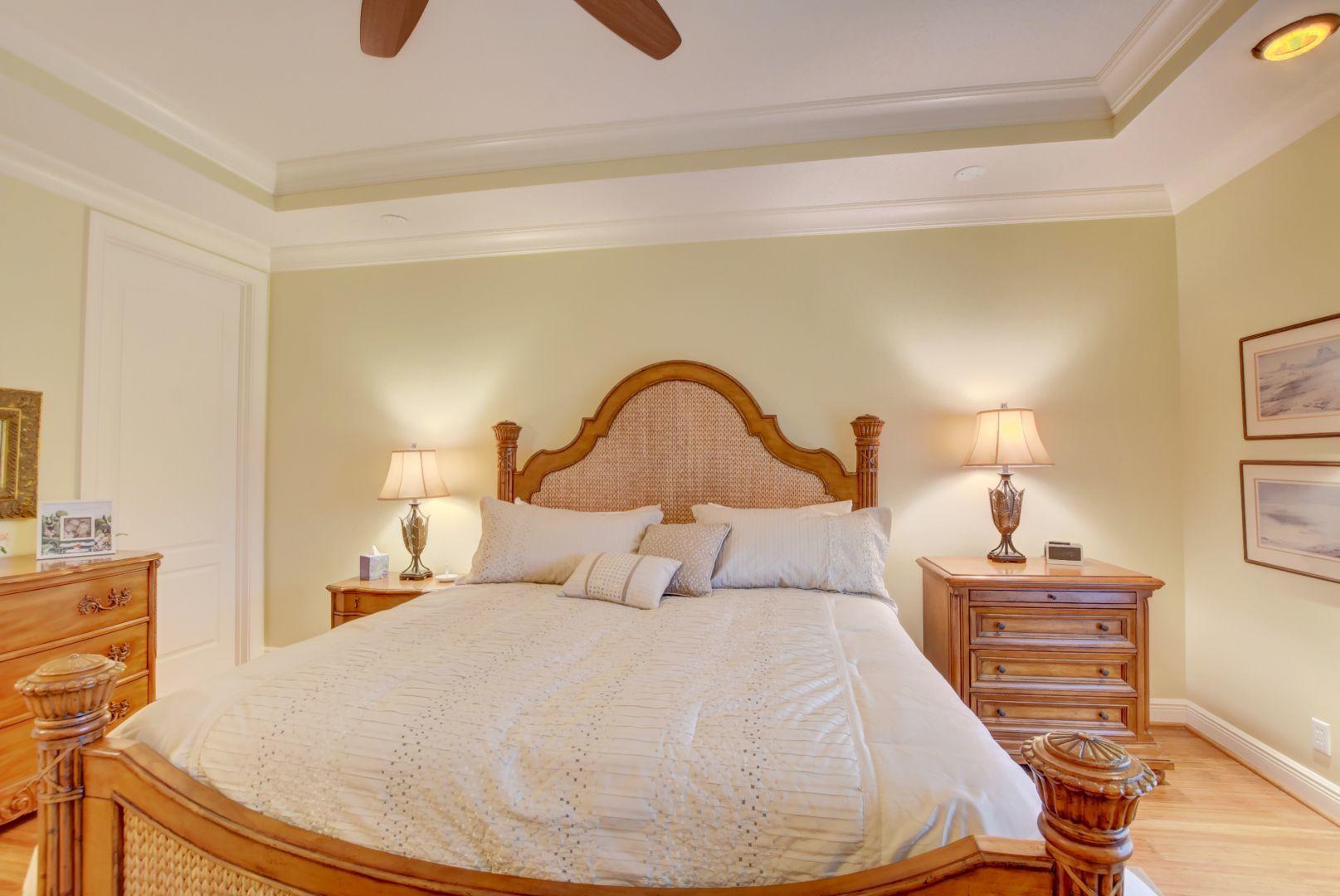 5530 Northeast Trieste Way Boca Raton, FL 33487 - Photo 18 of 56 a bedroom with a bed and a dresser with mirror