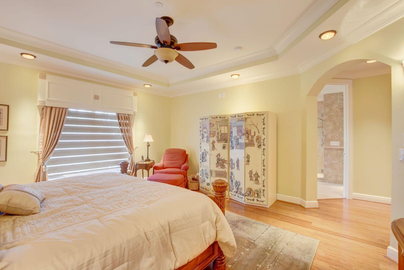 5530 Northeast Trieste Way Boca Raton, FL 33487 - Photo 19 of 56 a bedroom with a bed and wooden floor
