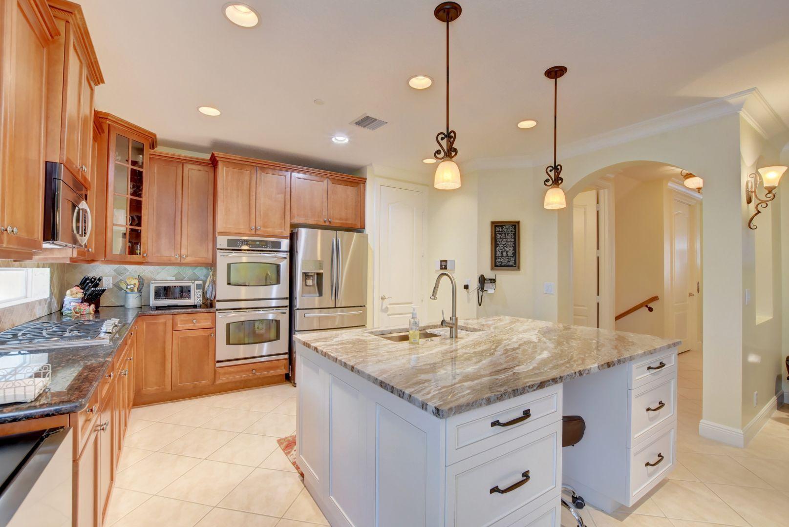 5530 Northeast Trieste Way Boca Raton, FL 33487 - Photo 2 of 56 a kitchen with stainless steel appliances granite countertop a sink a stove and a refrigerator