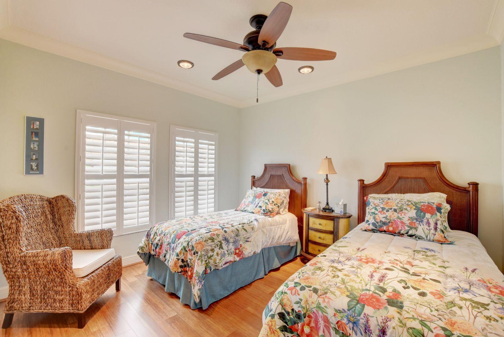 5530 Northeast Trieste Way Boca Raton, FL 33487 - Photo 22 of 56 a bedroom with two beds and a couch