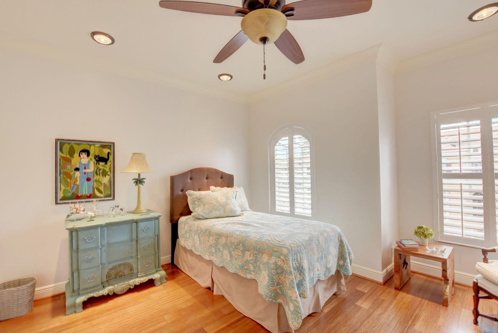 5530 Northeast Trieste Way Boca Raton, FL 33487 - Photo 24 of 56 a bedroom with a bed and wooden floor
