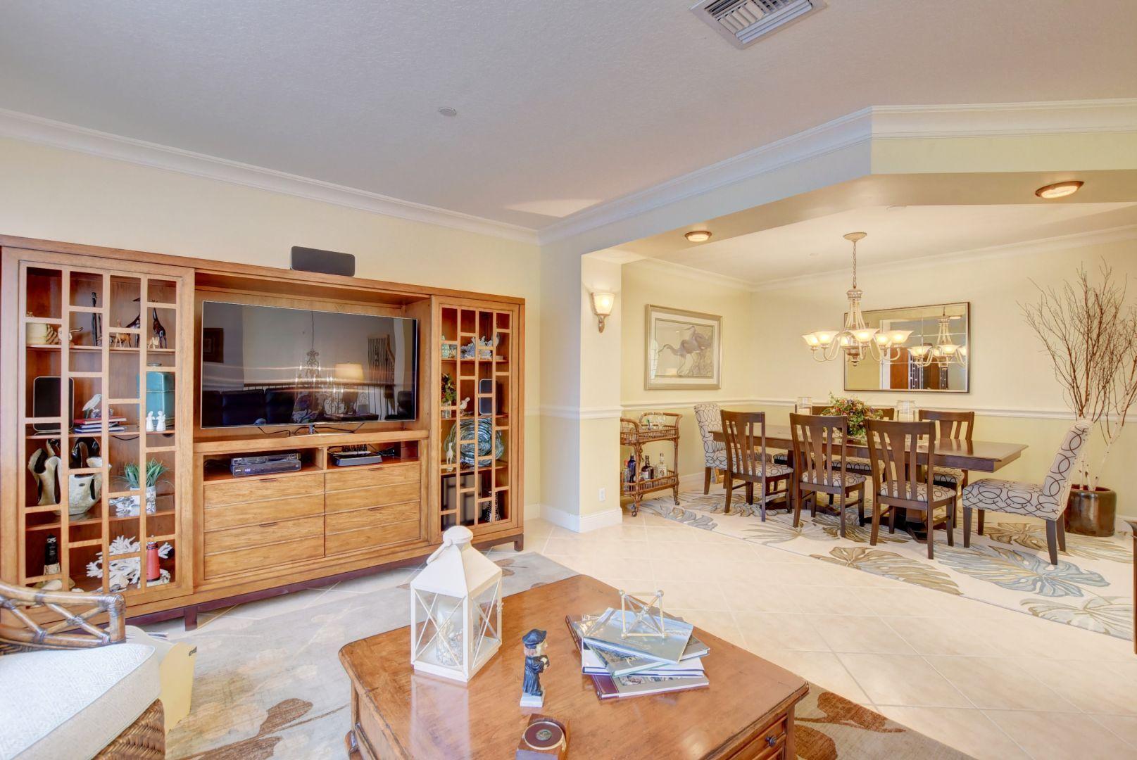 5530 Northeast Trieste Way Boca Raton, FL 33487 - Photo 28 of 56 a living room with furniture kitchen view and a large window