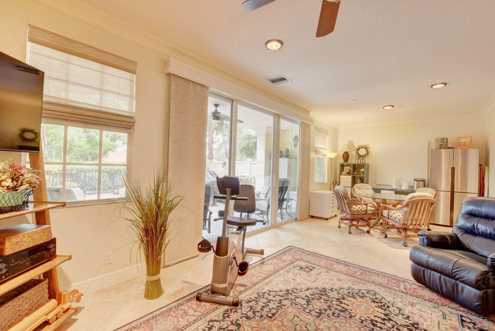 5530 Northeast Trieste Way Boca Raton, FL 33487 - Photo 31 of 56 a living room with furniture and large windows