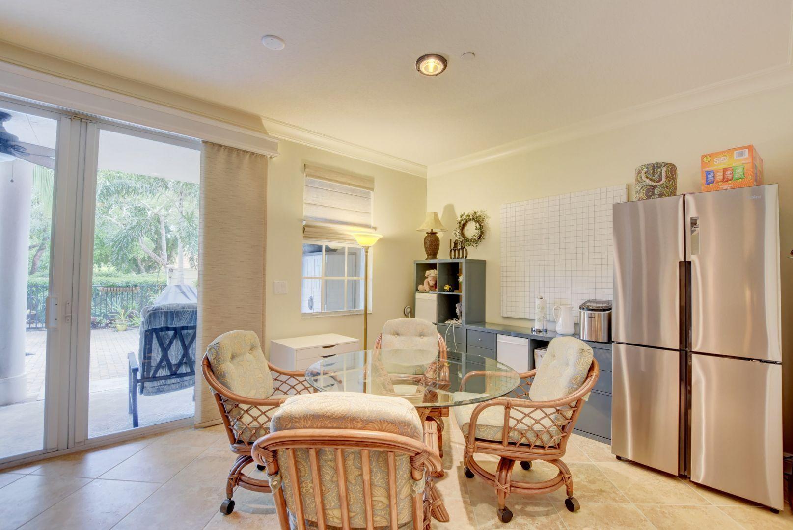 5530 Northeast Trieste Way Boca Raton, FL 33487 - Photo 33 of 56 a view of a dining room with furniture window and wooden floor