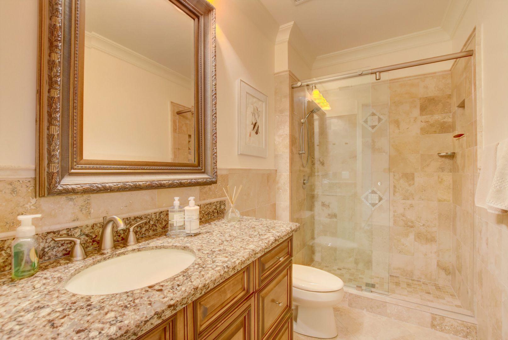 5530 Northeast Trieste Way Boca Raton, FL 33487 - Photo 34 of 56 a bathroom with a granite countertop sink toilet and shower