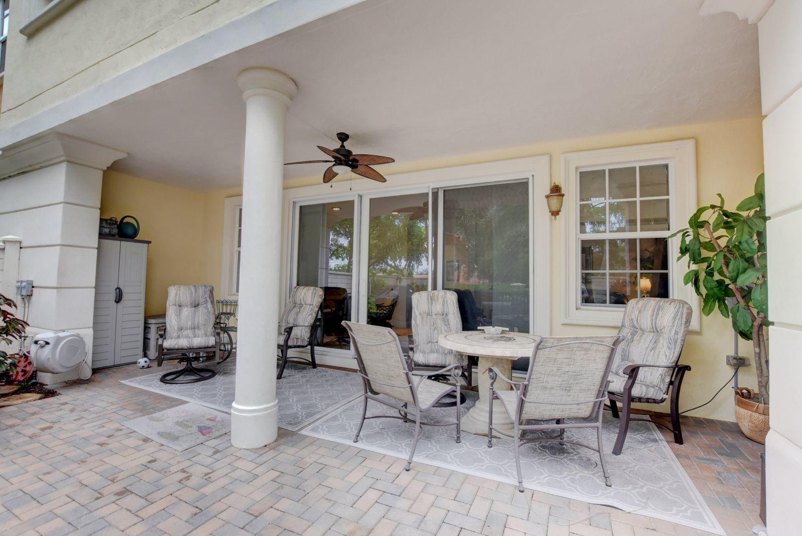5530 Northeast Trieste Way Boca Raton, FL 33487 - Photo 35 of 56 a view of a dining room with furniture and a potted plant