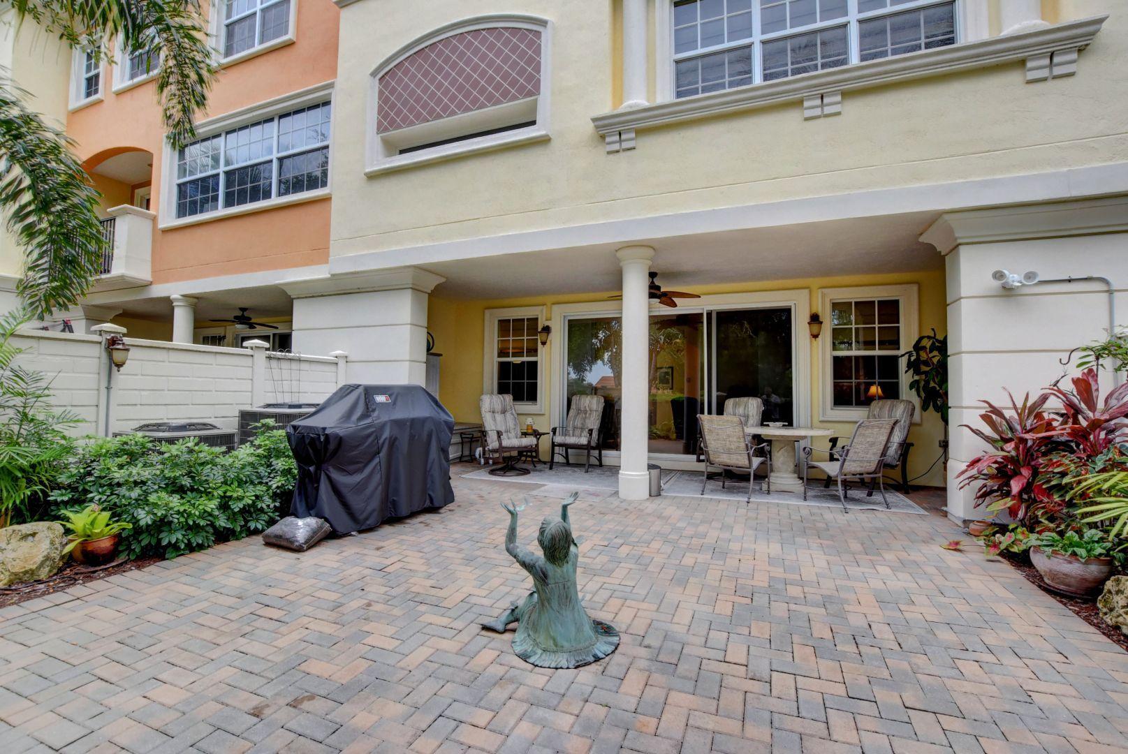 5530 Northeast Trieste Way Boca Raton, FL 33487 - Photo 36 of 56 a view of a building with sitting area