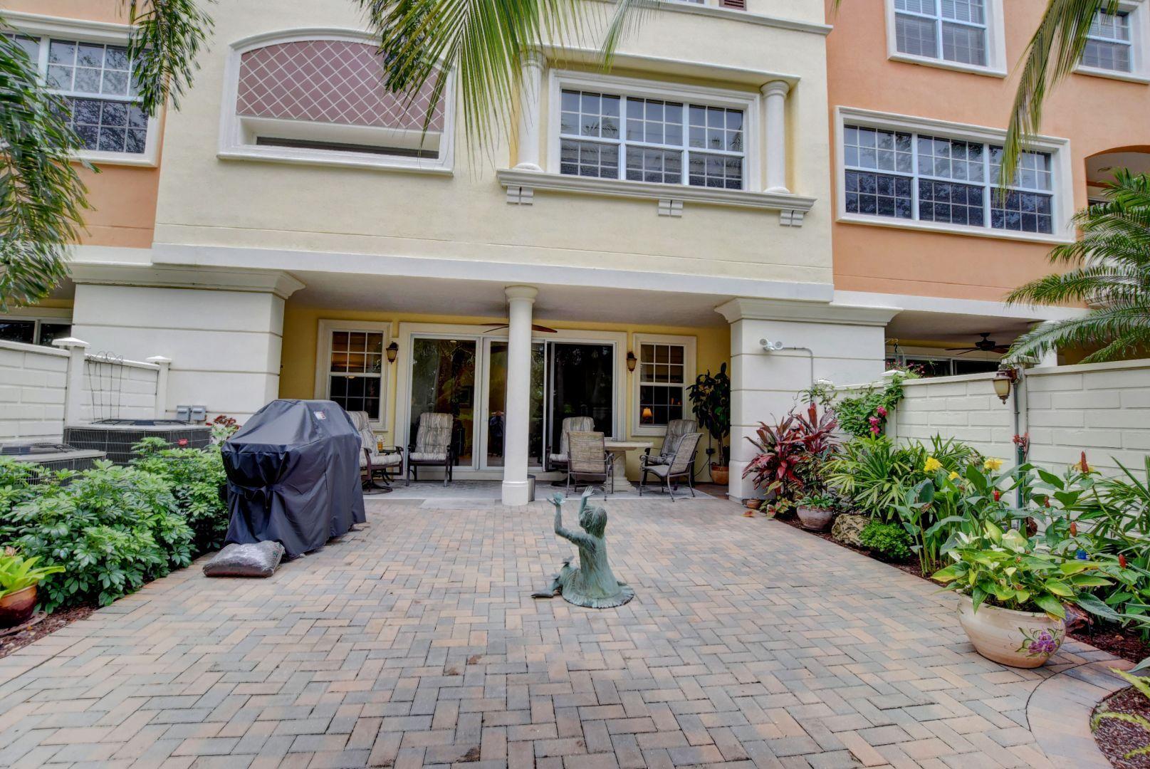 5530 Northeast Trieste Way Boca Raton, FL 33487 - Photo 37 of 56 a view of a house with sitting area and garden