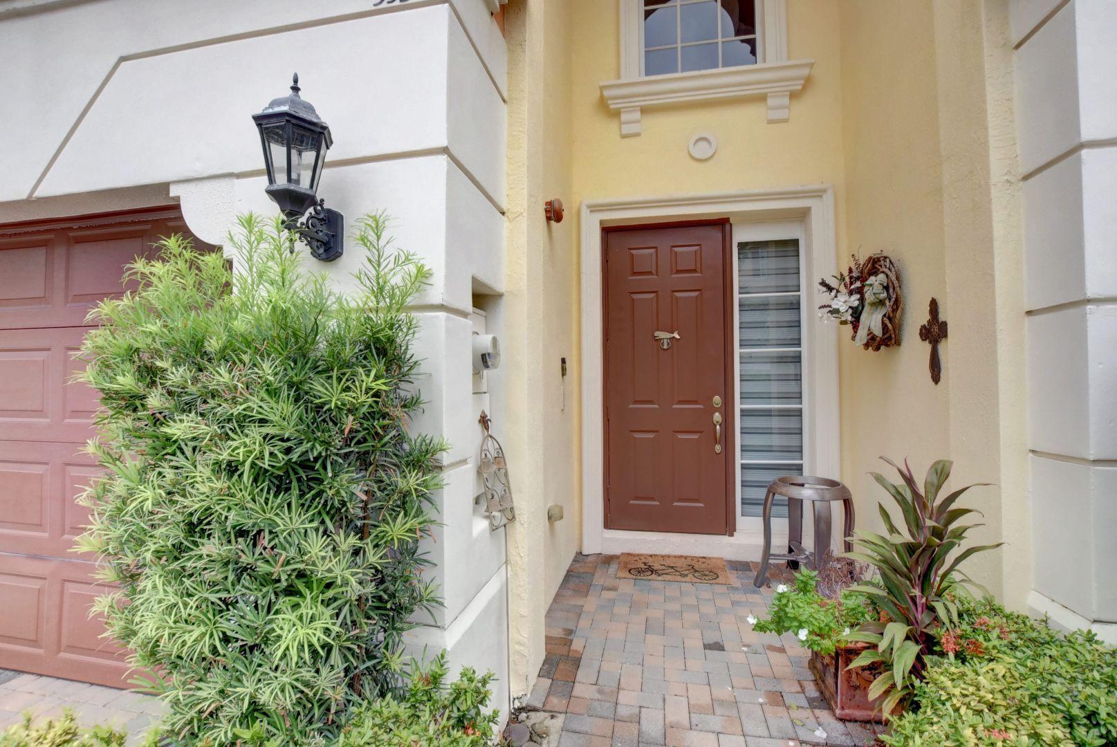 5530 Northeast Trieste Way Boca Raton, FL 33487 - Photo 40 of 56 a front view of a house with plants