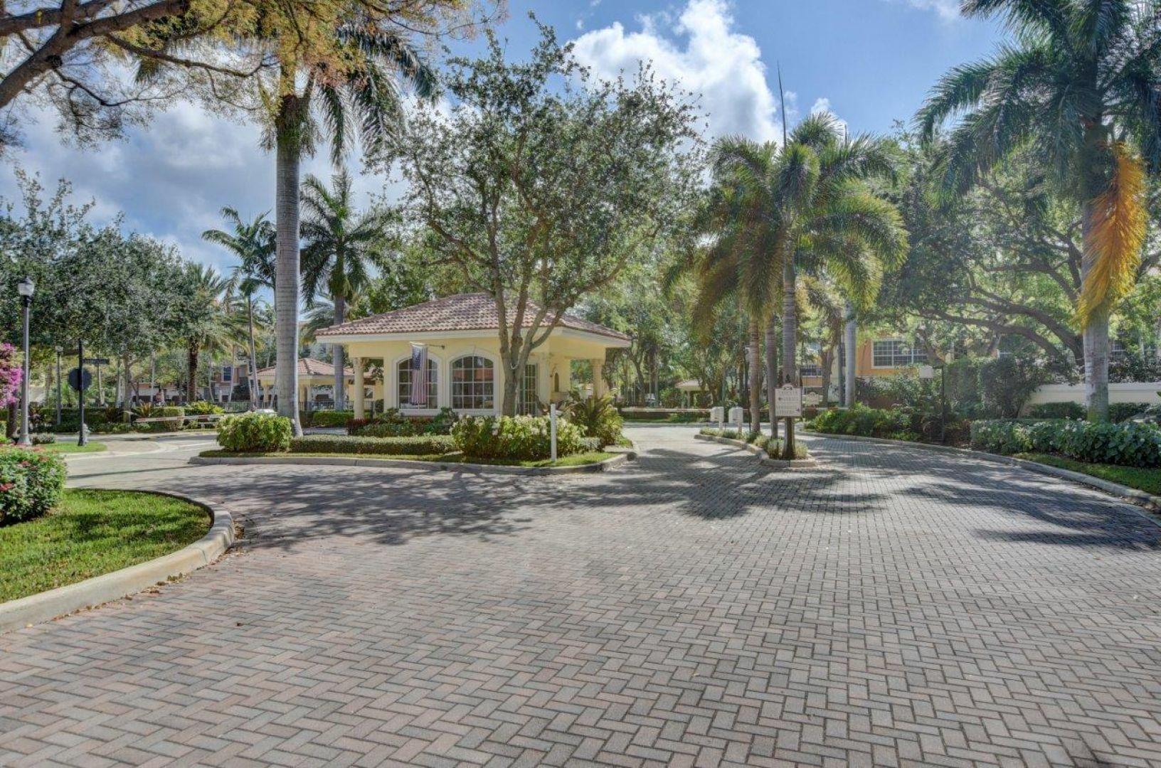 5530 Northeast Trieste Way Boca Raton, FL 33487 - Photo 44 of 56 a view of a house with a yard and palm trees