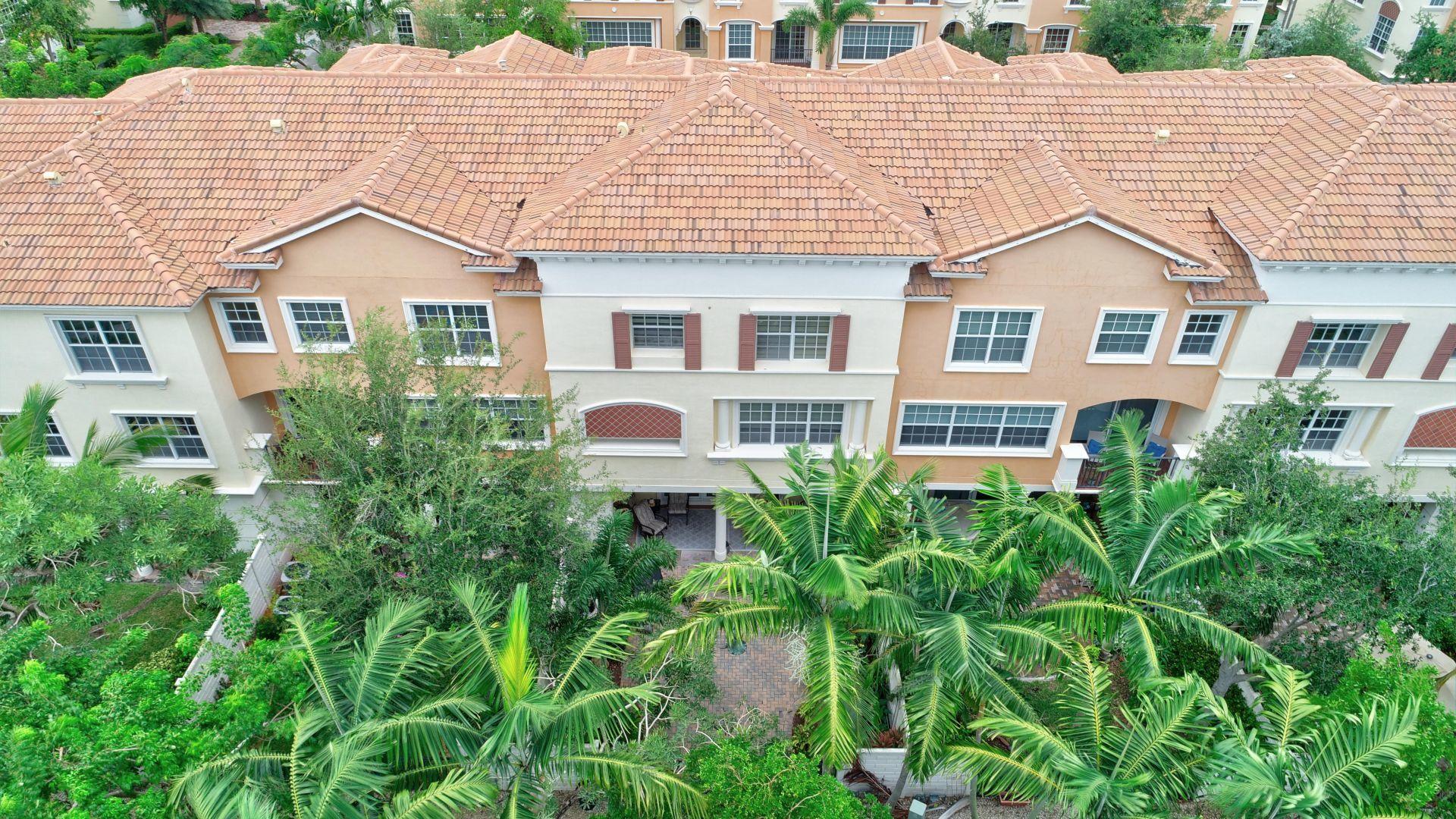 5530 Northeast Trieste Way Boca Raton, FL 33487 - Photo 53 of 56 a view of house with a yard and potted plants
