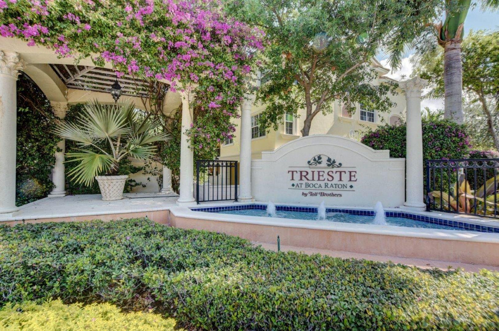 5530 Northeast Trieste Way Boca Raton, FL 33487 - Photo 55 of 56 a view of a sign in a yard with potted plants and tree