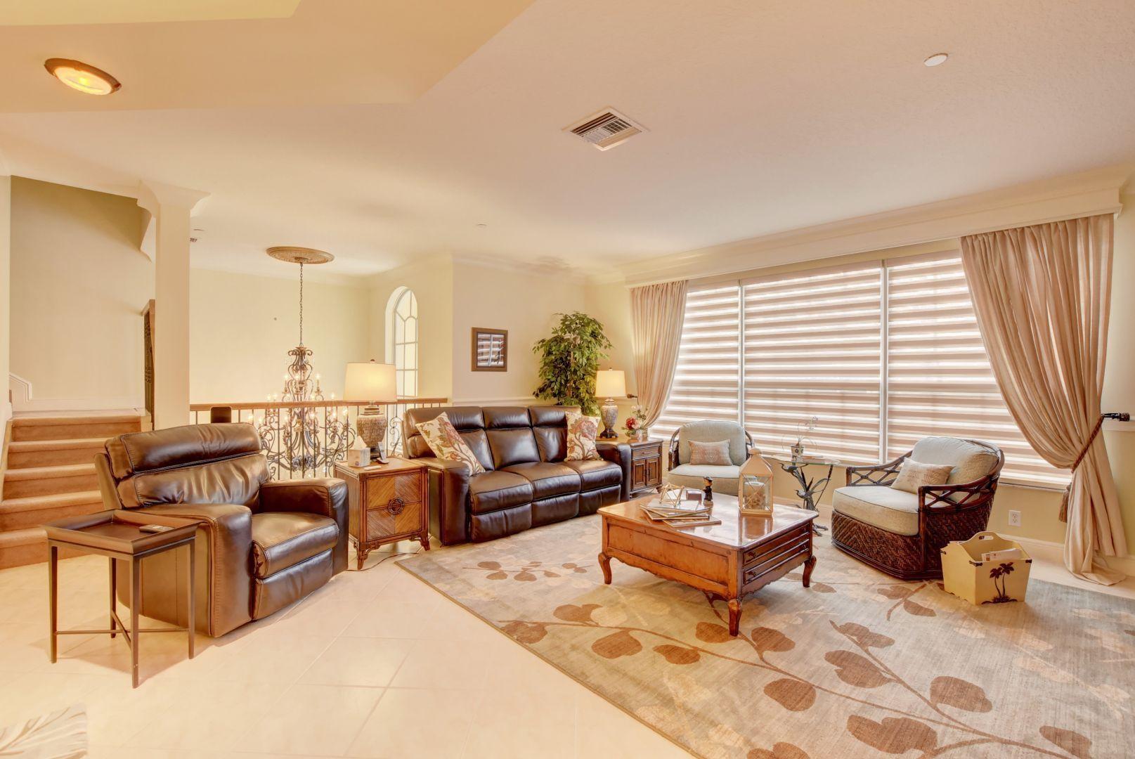 5530 Northeast Trieste Way Boca Raton, FL 33487 - Photo 10 of 56 a living room with furniture and floor to ceiling window